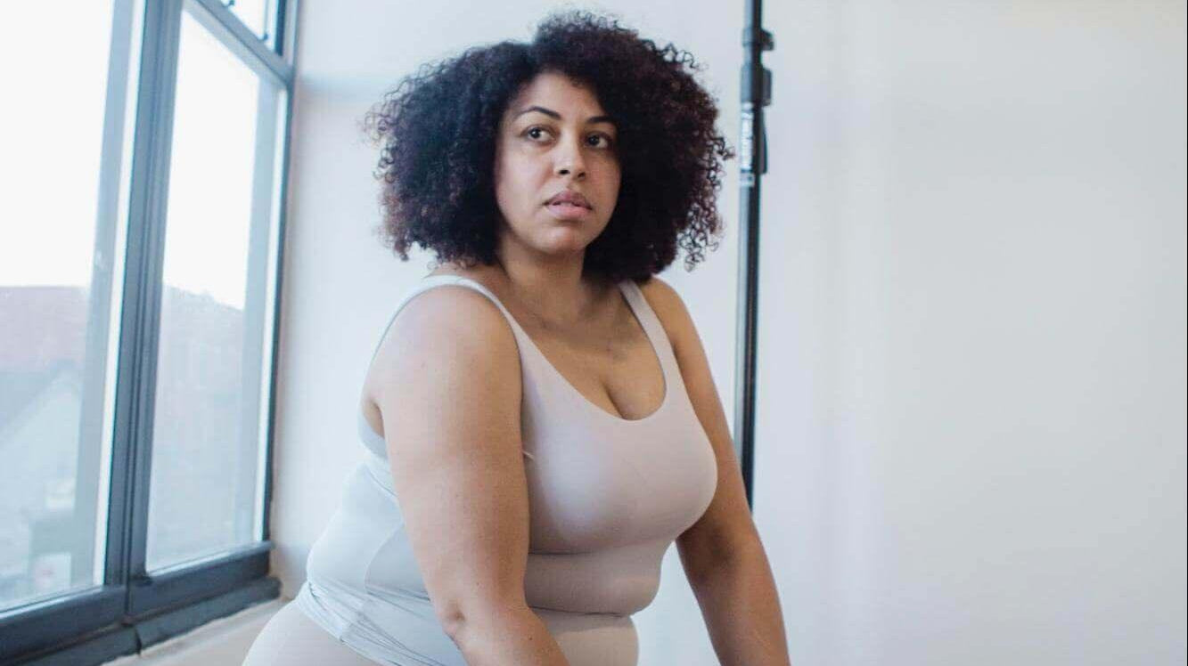 Alt-txt: woman sitting down while wearing undergarments
