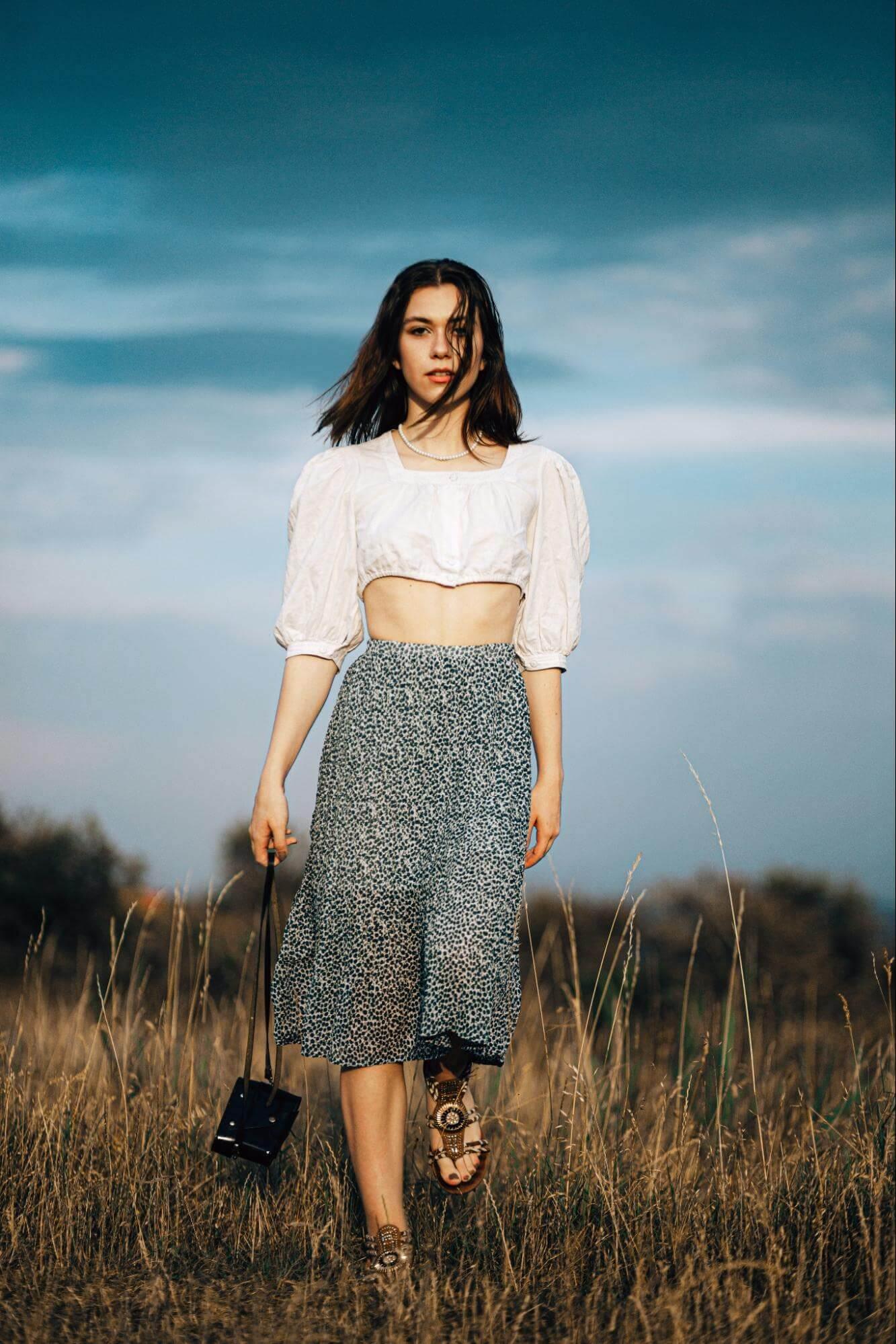Woman in a field wearing a skirt