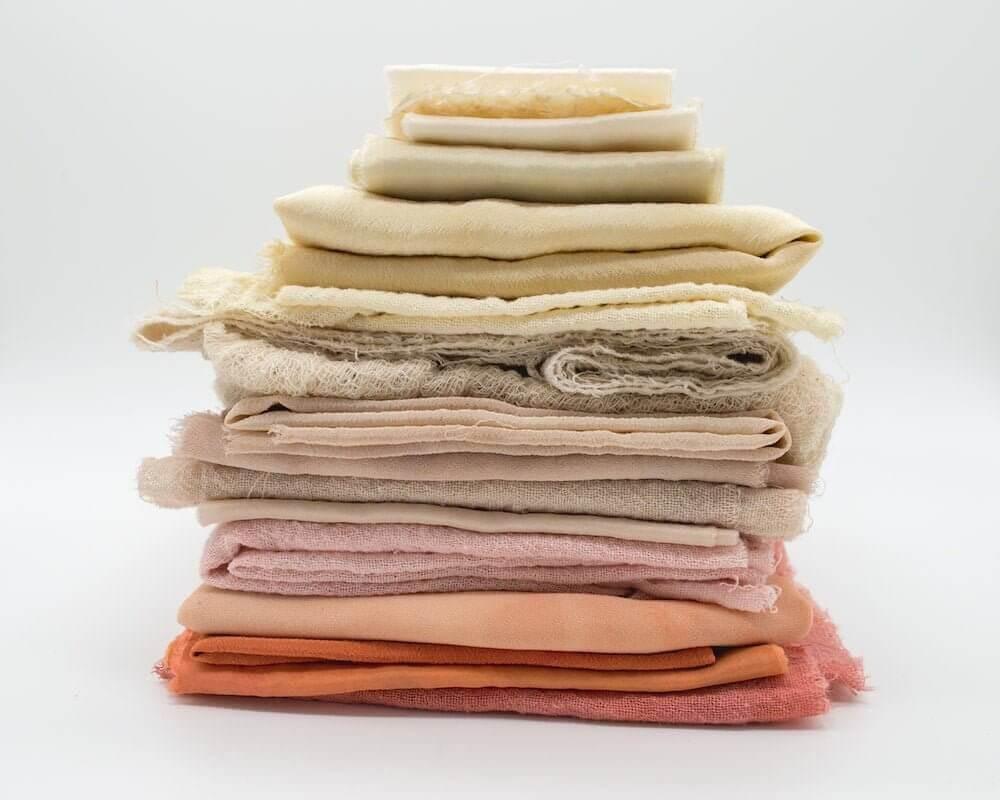 Alt-txt: a pile of different colored cotton fabrics 