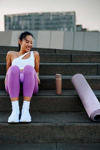 woman sitting on stairs with workout leggings